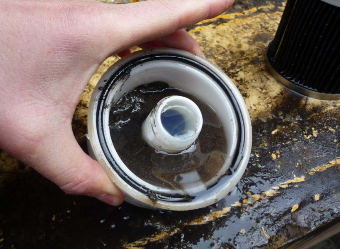 Water and sludge in non-genuine fuel filter bowl